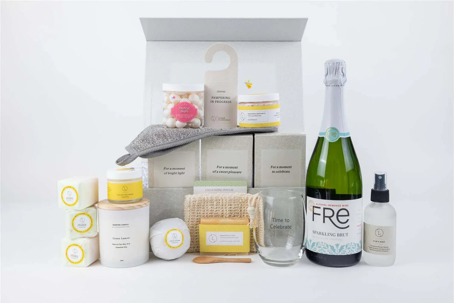 All-natural citrus skincare gift box with bath items, candle, sparkling brut, and pampering accessories
