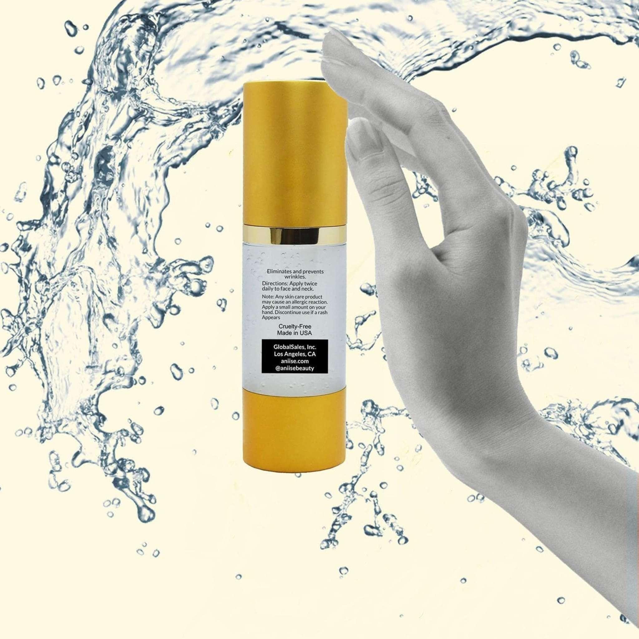 Gold anti-aging collagen facial serum bottle held by a hand, with water splash background