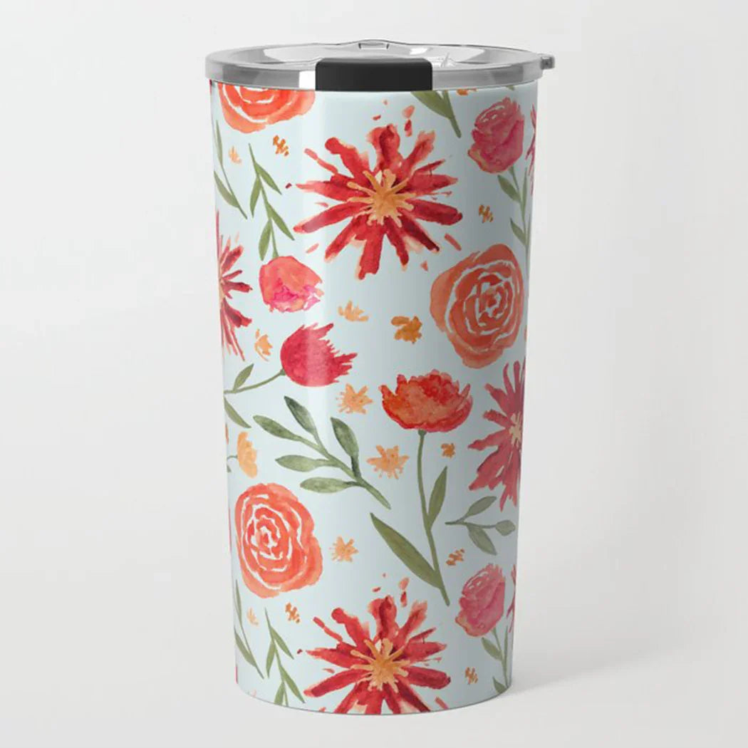 Stainless steel tumbler with watercolor style floral pattern in red, orange, and green on light blue background