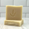 Handcrafted bar soap with leaf imprint on a marble surface, Qu!rk Boutique eco-friendly gift