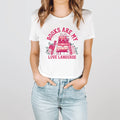 Woman wearing a white cropped t-shirt with pink 'Books Are My Love Language' graphic and book illustration