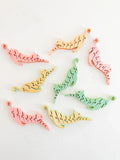 Pastel cat-shaped fidget toys arranged on a white background, playful artisan gift at Qu!rk Boutique.