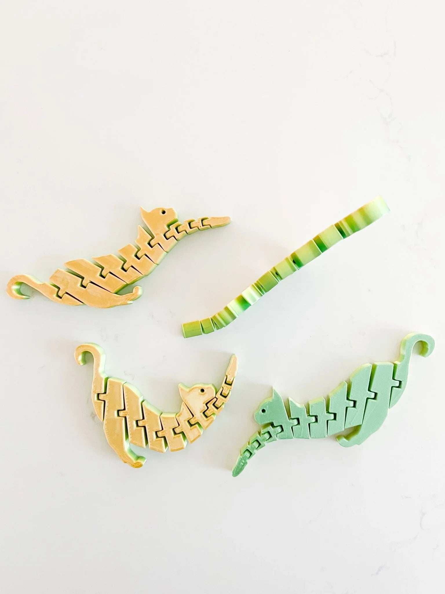 Pastel cat-shaped fidget toys on white background, artist-designed gift from Qu!rk Boutique