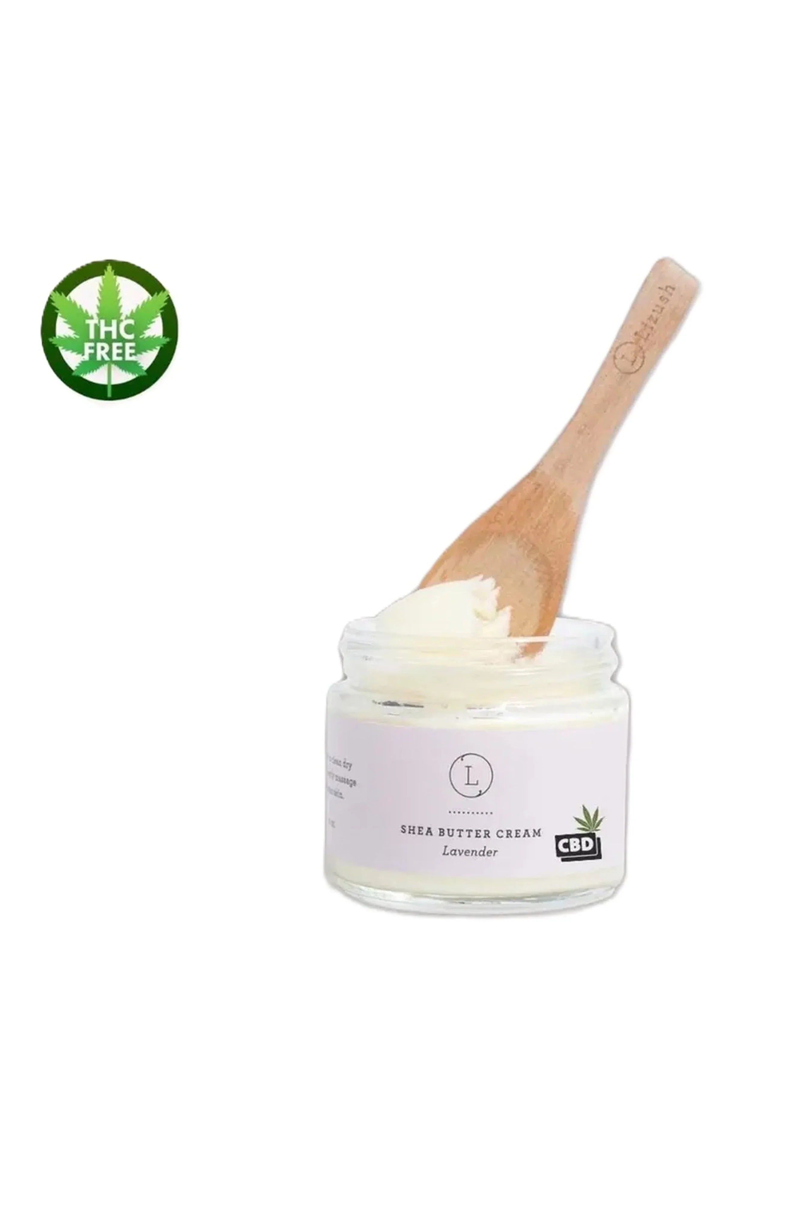 Jar of lavender shea butter cream with CBD label and wooden spatula, THC free symbol
