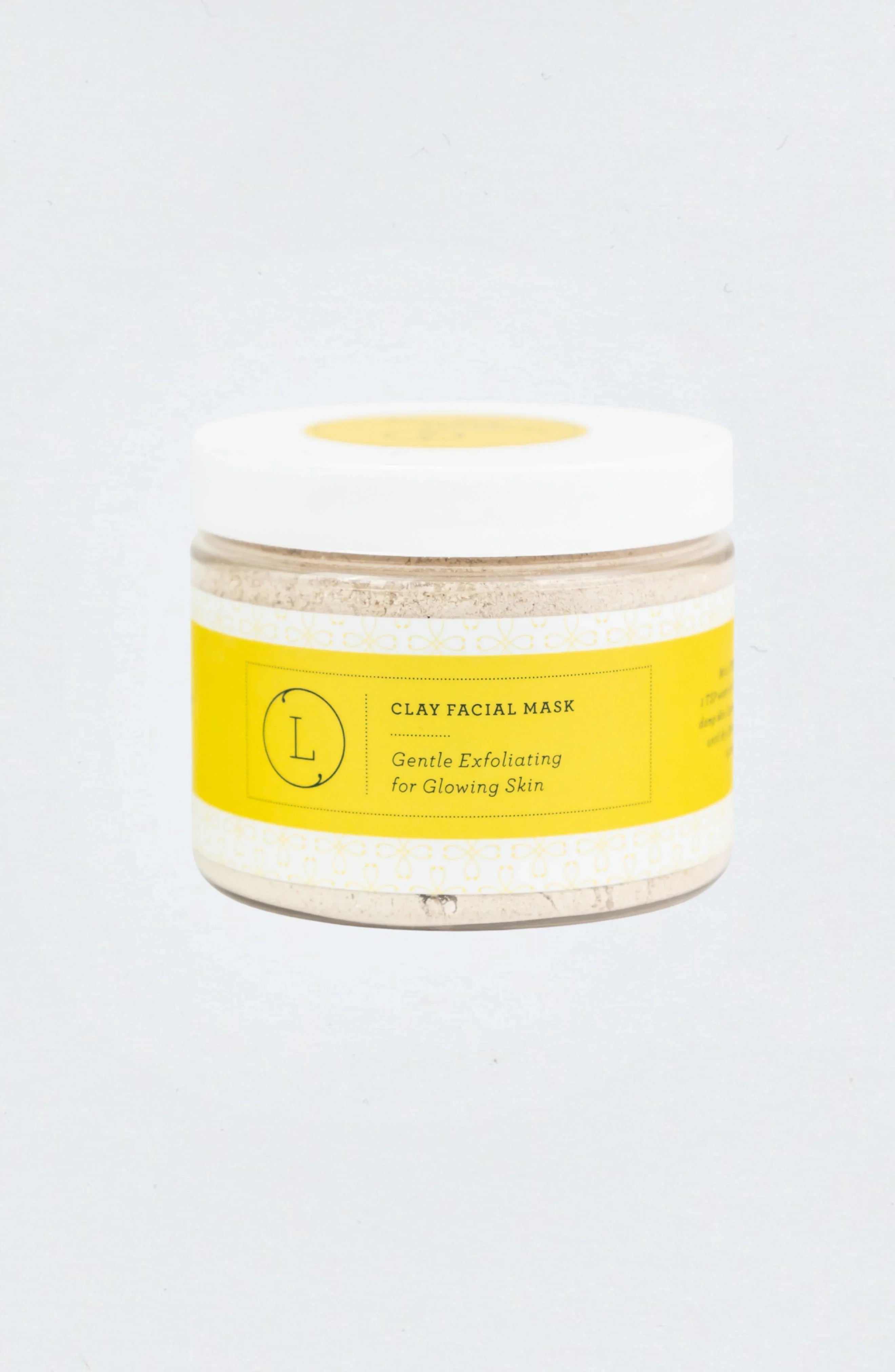 Clay facial mask jar with yellow label for gentle exfoliating and glowing skin