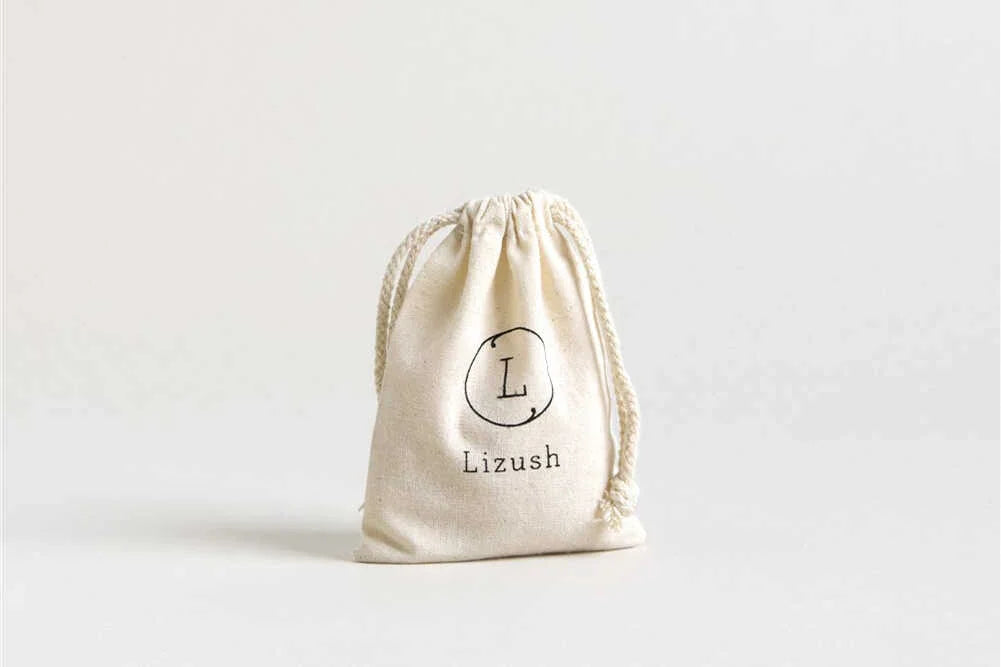 Natural cotton drawstring pouch bag with Lizush logo on white background
