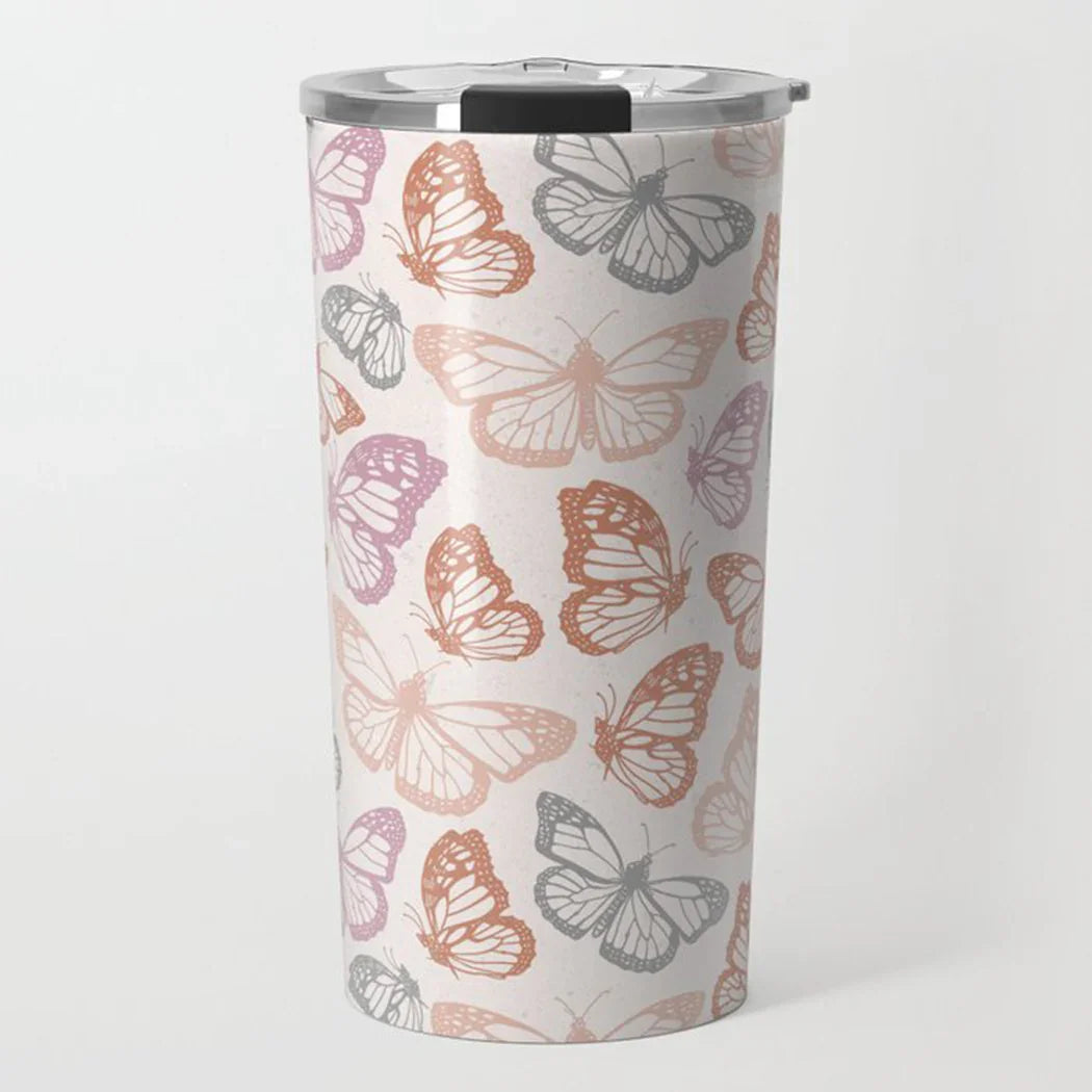 Reusable travel tumbler with pastel butterfly pattern and silver lid on white background