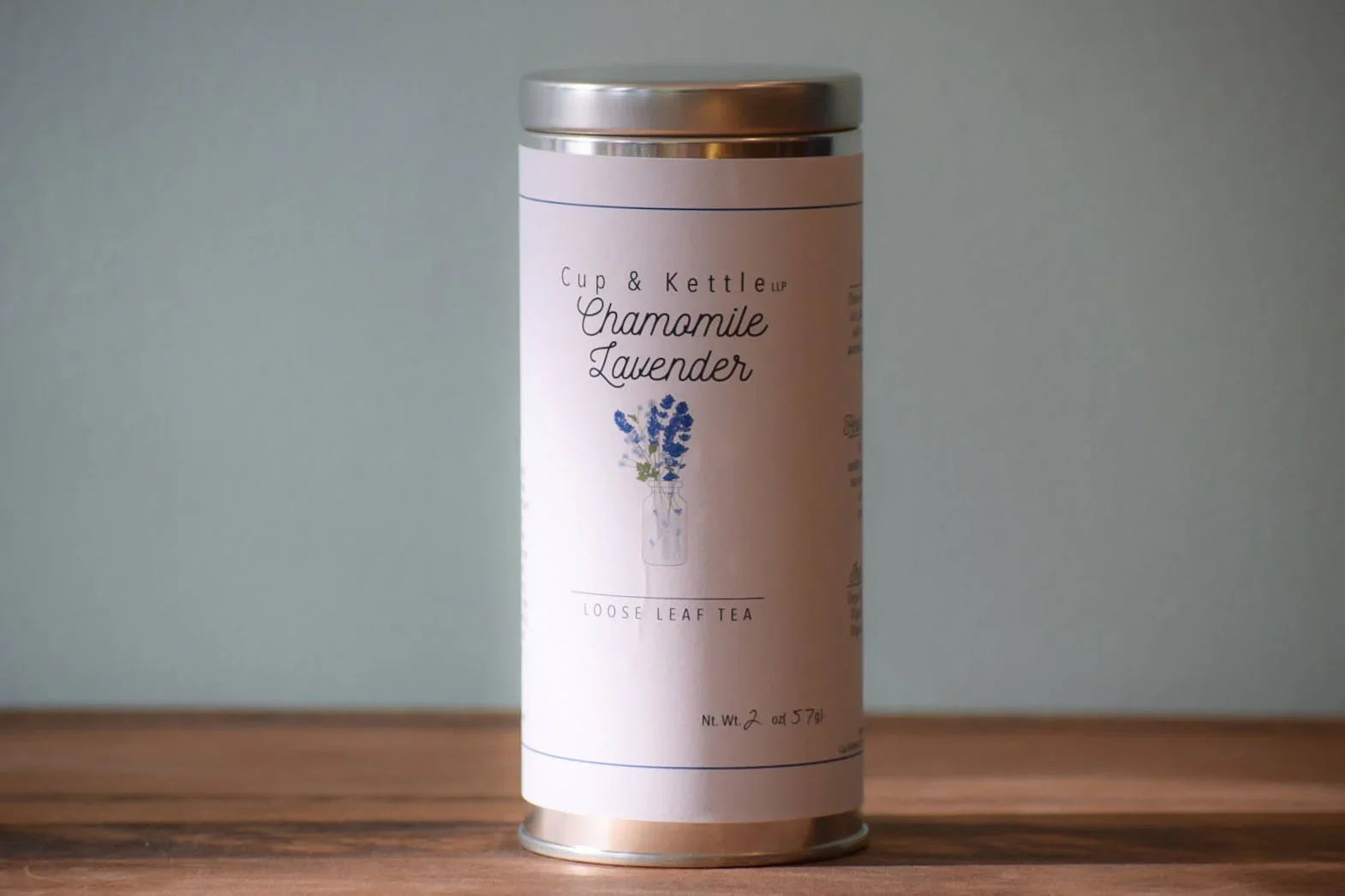Cup & Kettle chamomile lavender loose leaf tea tin with floral label on wooden surface