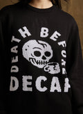 Black sweater with white skull and coffee cup graphic and text reading 'Death Before Decaf'