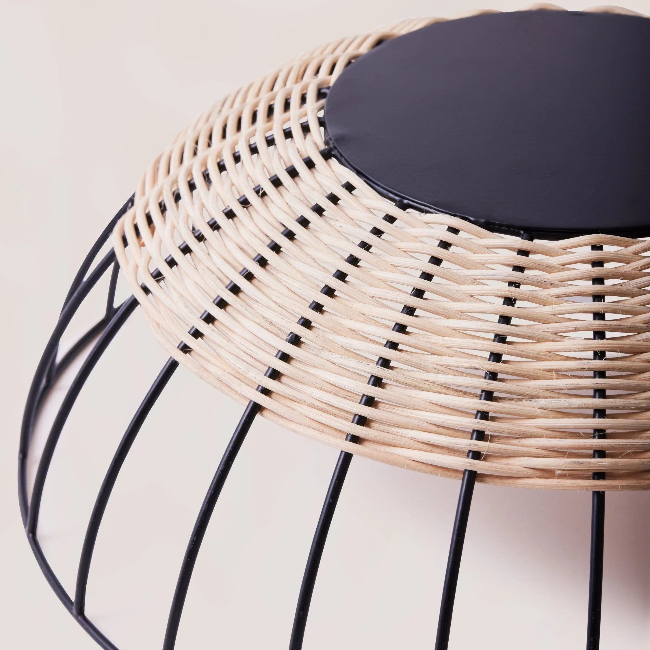 Close-up of a modern wicker and black metal basket from Qu!rk Boutique