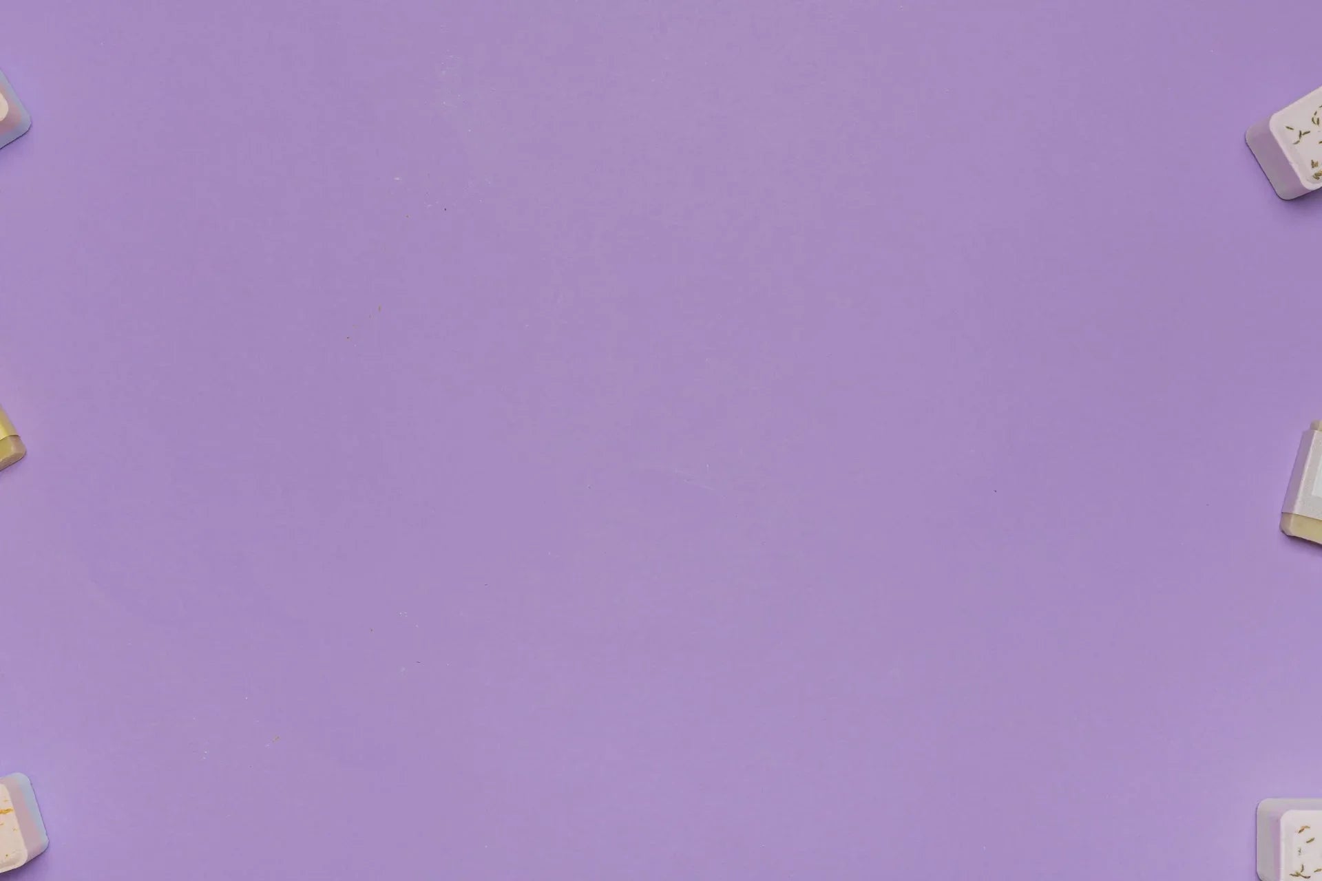 Minimalist flat lay with white rectangular soap bars on purple background