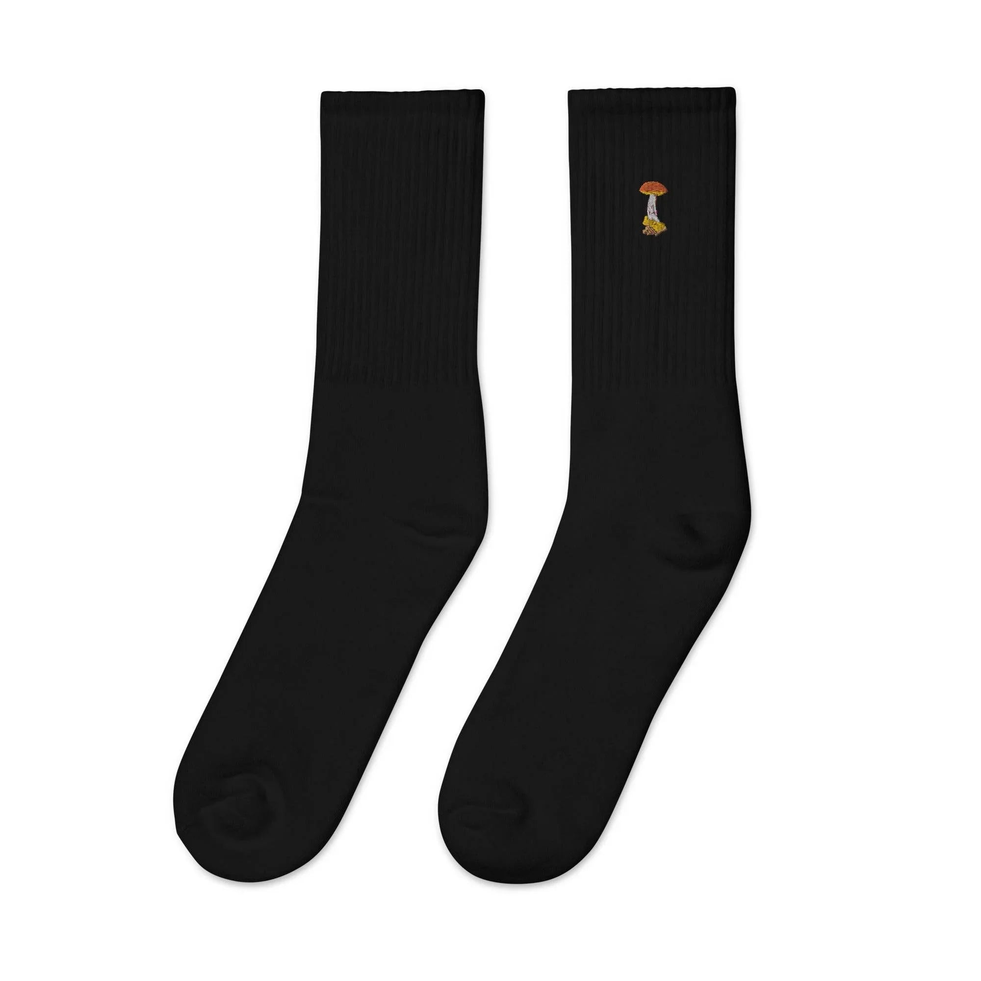 Pair of black embroidered crew socks with a small colorful mushroom design on one side