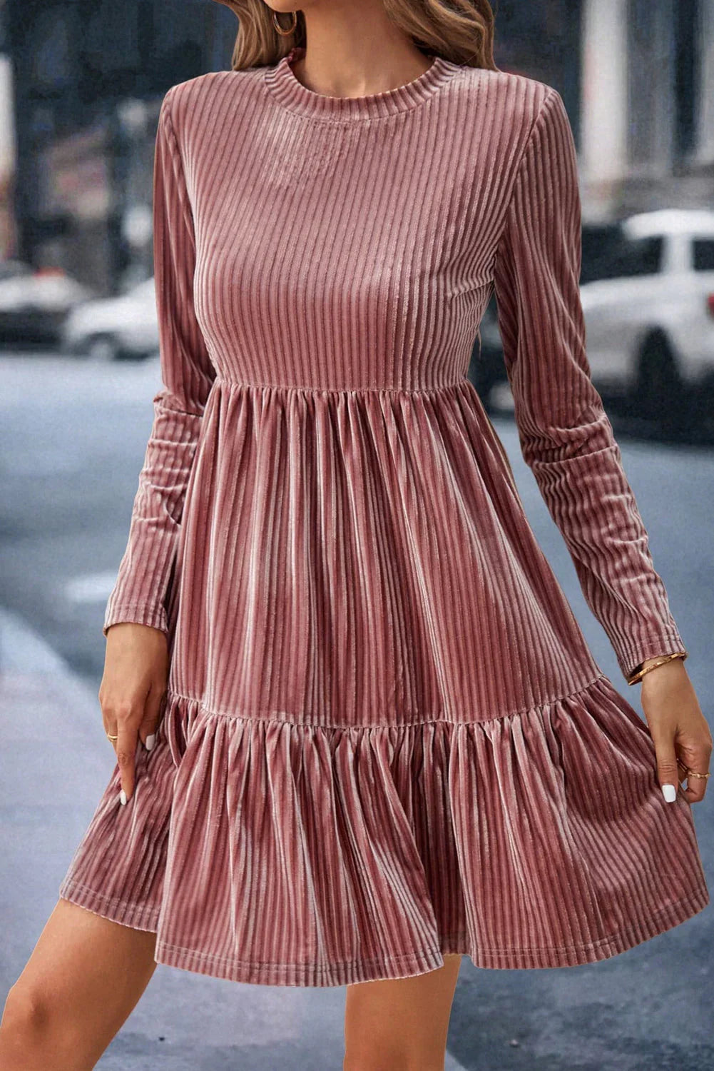 Woman wearing a pink velvet ribbed long sleeve dress, styled for Qu!rk Boutique's winter collection