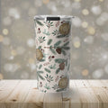 Insulated tumbler with winter woodland pattern of pinecones, leaves, and tree rings on white