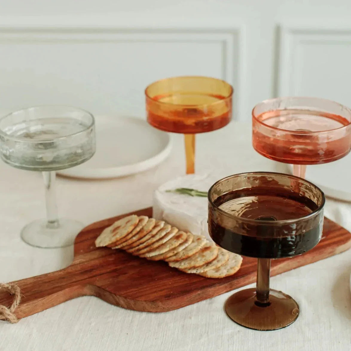 Colorful cocktail glasses with cheese and crackers on wood board, Qu!rk Boutique tableware