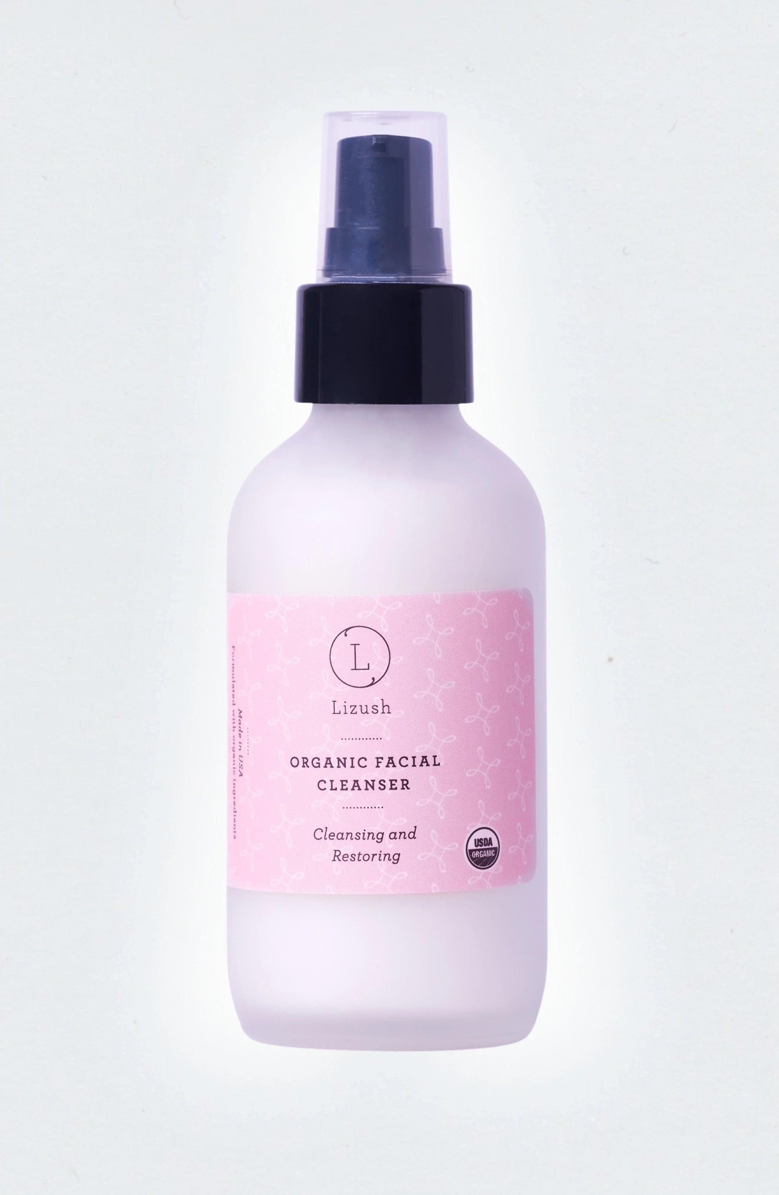 Lizush organic facial cleanser in frosted bottle with pink label and black pump