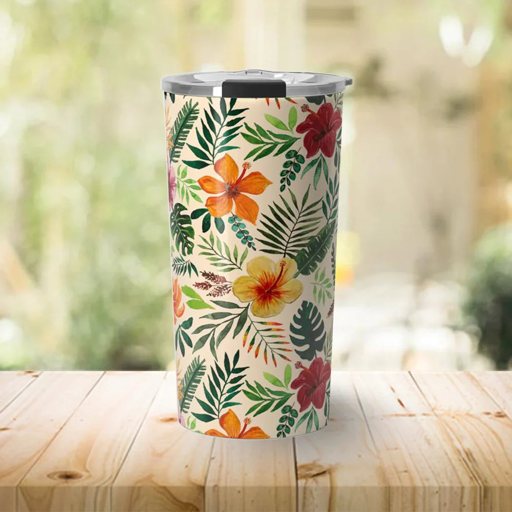 Tropical floral insulated tumbler with stainless steel lid on wooden table