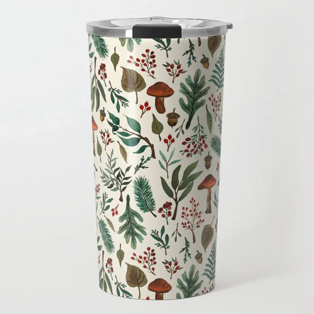 Tall travel tumbler with clear lid featuring botanical design of leaves, acorns, berries, and mushrooms