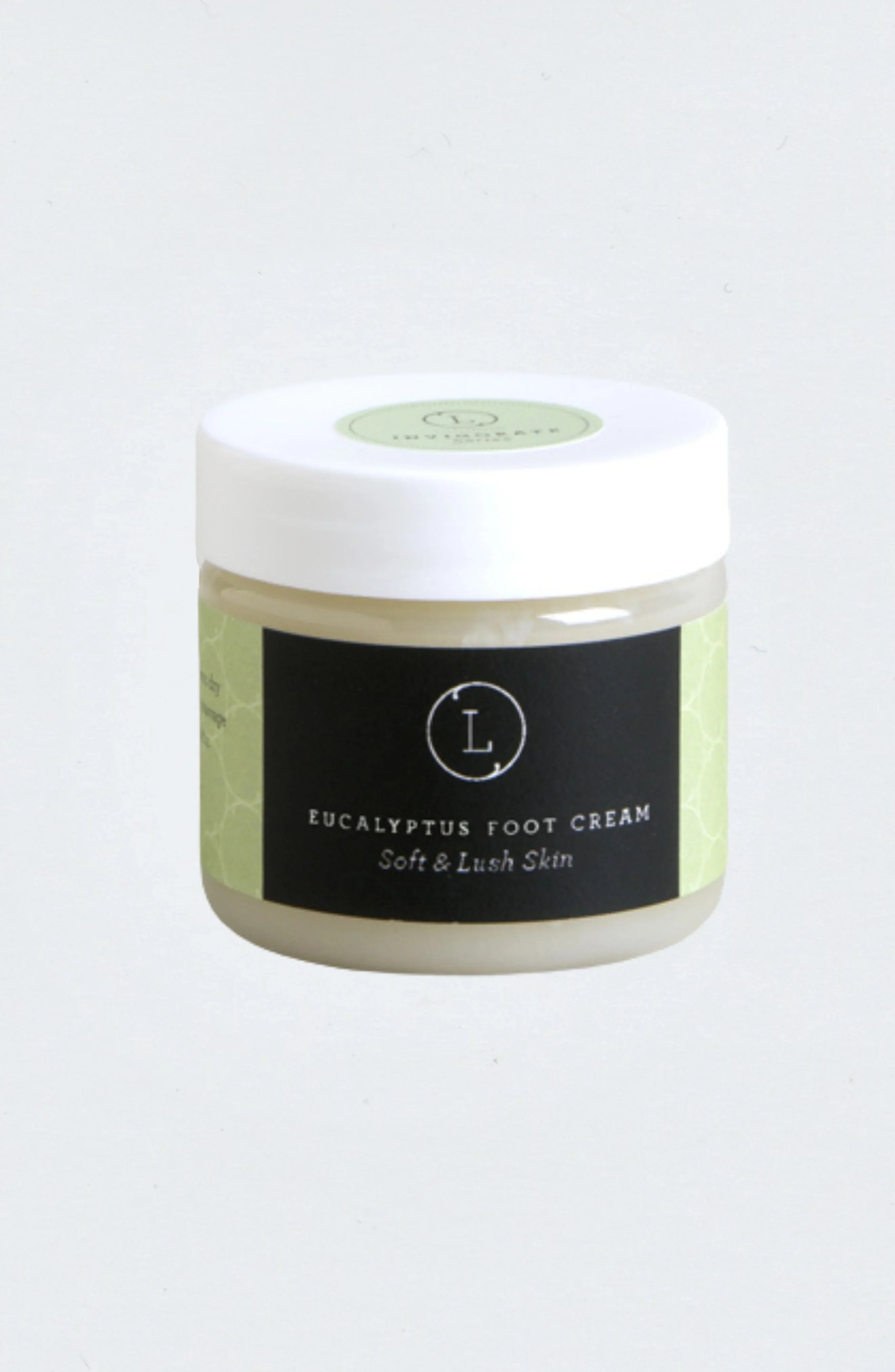 Jar of eucalyptus foot cream with white lid and black label for soft and lush skin