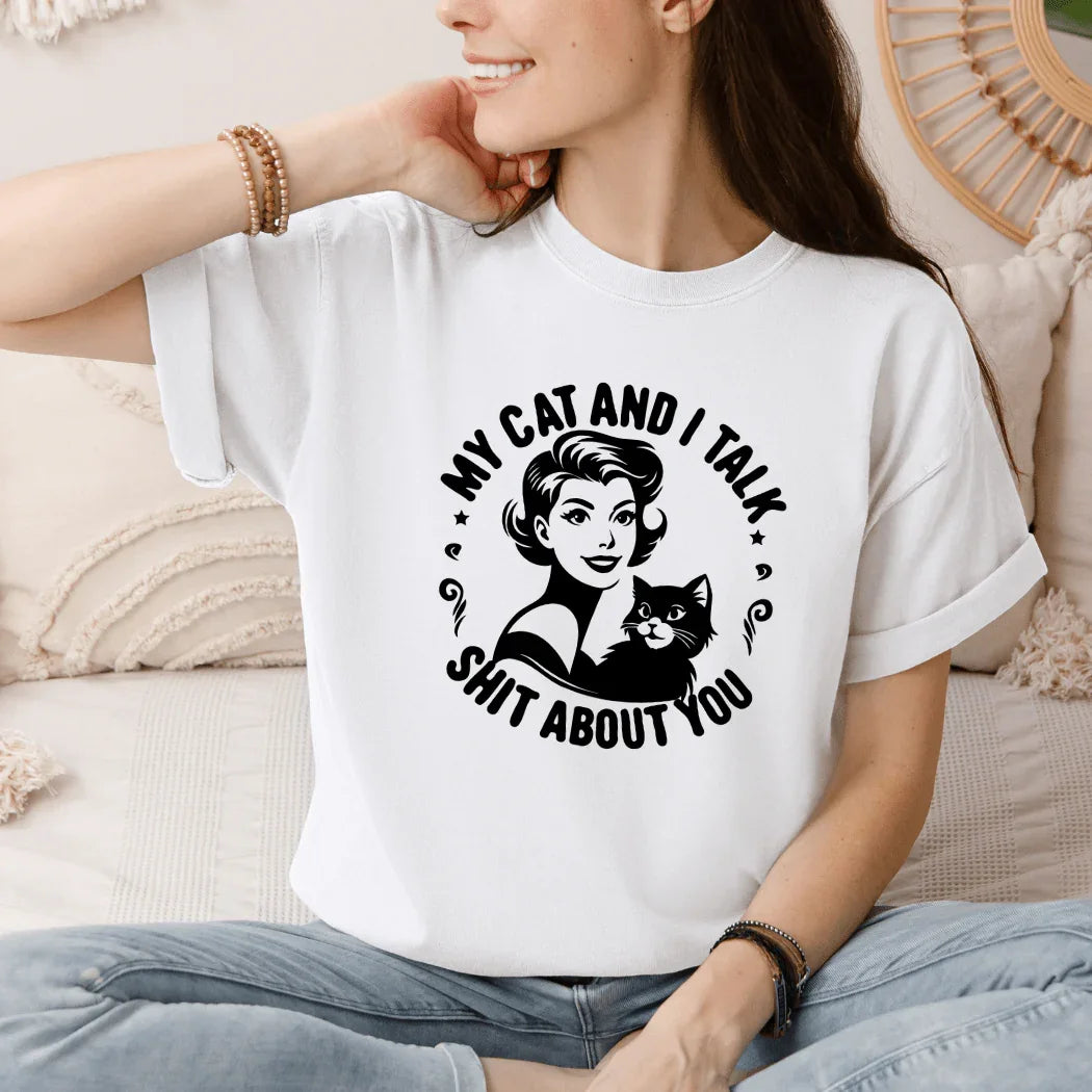 Woman wearing a white quirky cat lover graphic t-shirt, My Cat and I Talk Sh*t About You.