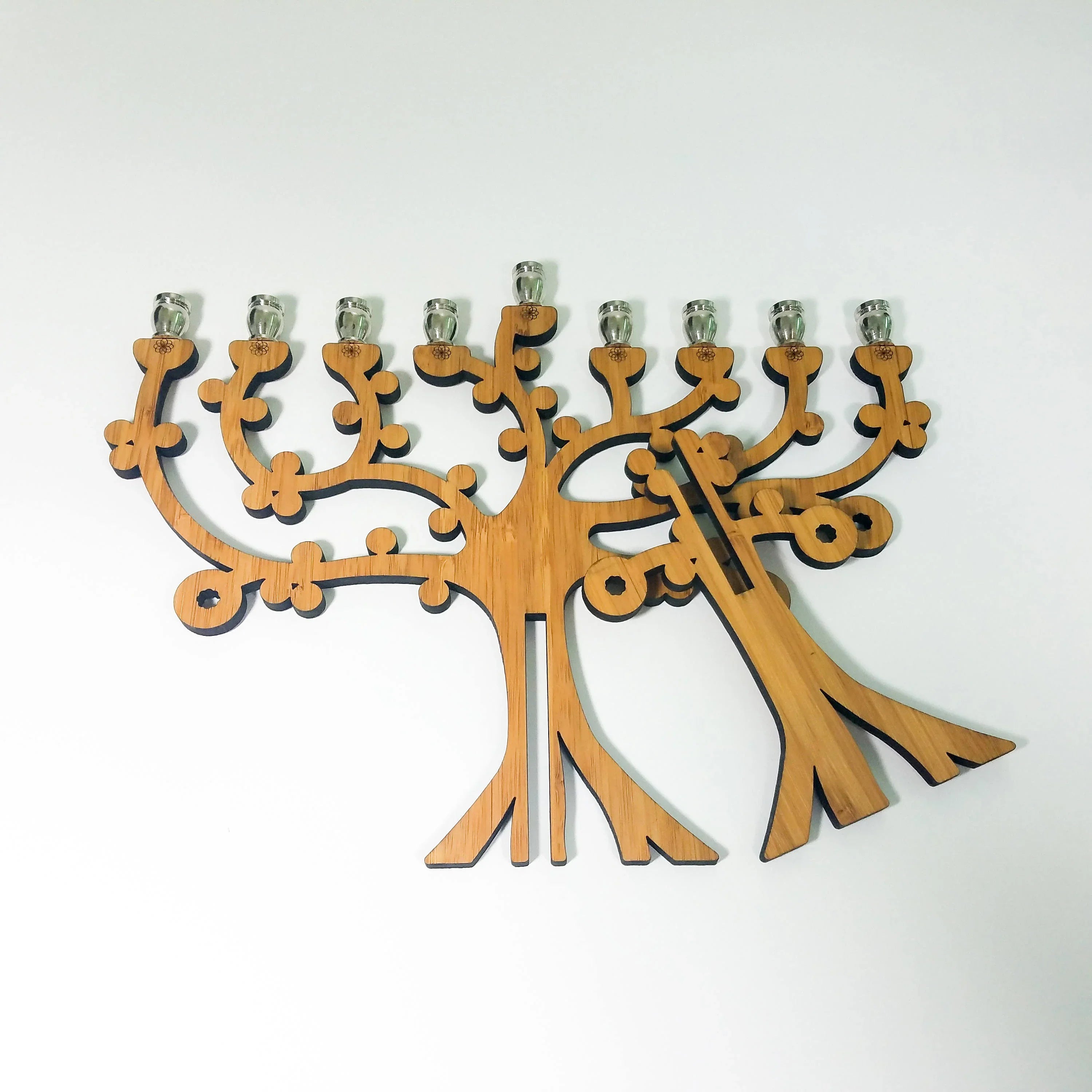 Handcrafted wooden menorah shaped like a stylized tree with eight candle holders and one shamash