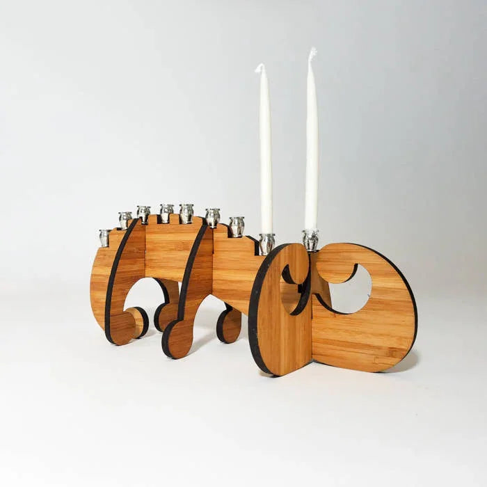 Modern wooden Hanukkah menorah with silver candle holders and two white candles