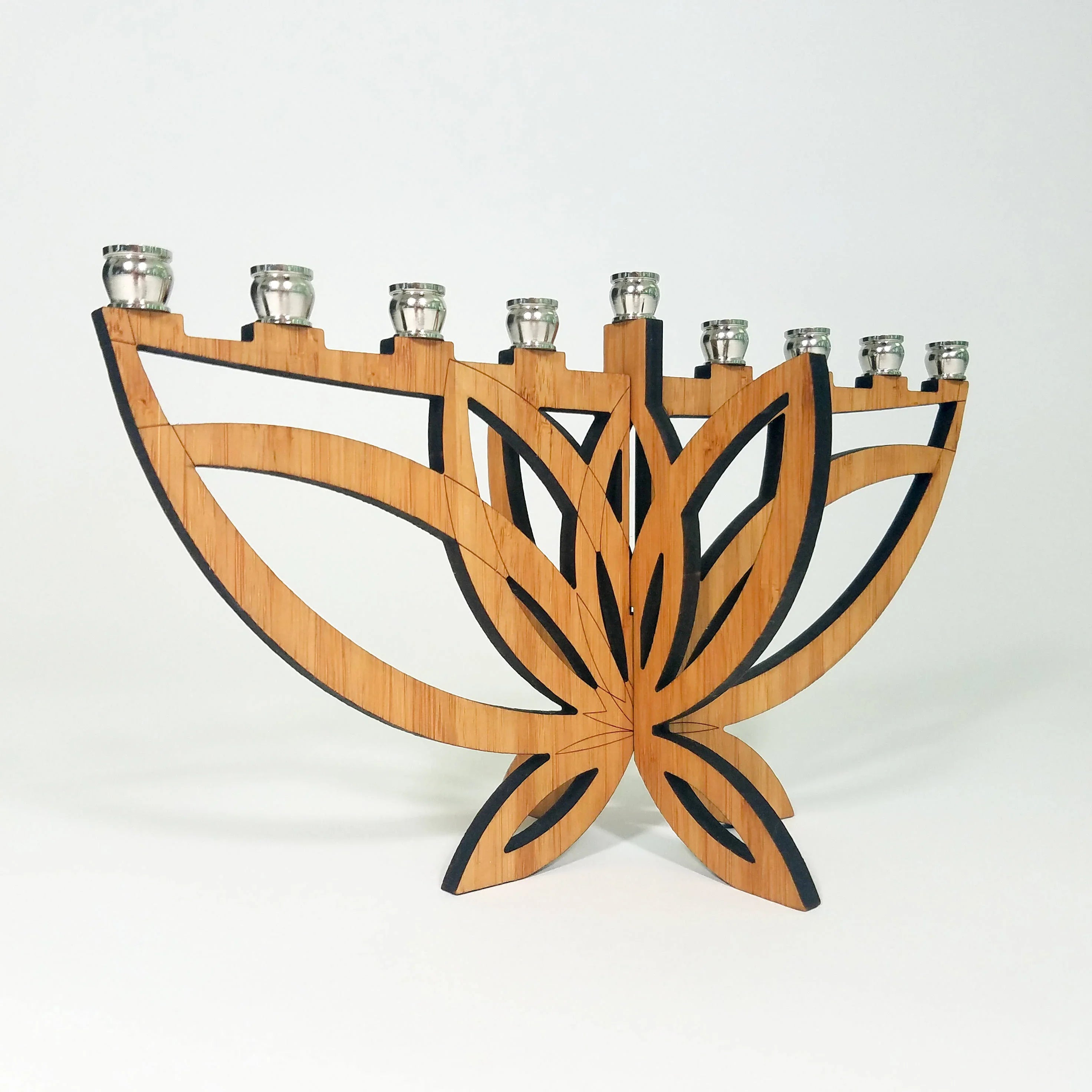 Wooden menorah with modern butterfly design and nine silver candle holders on white background