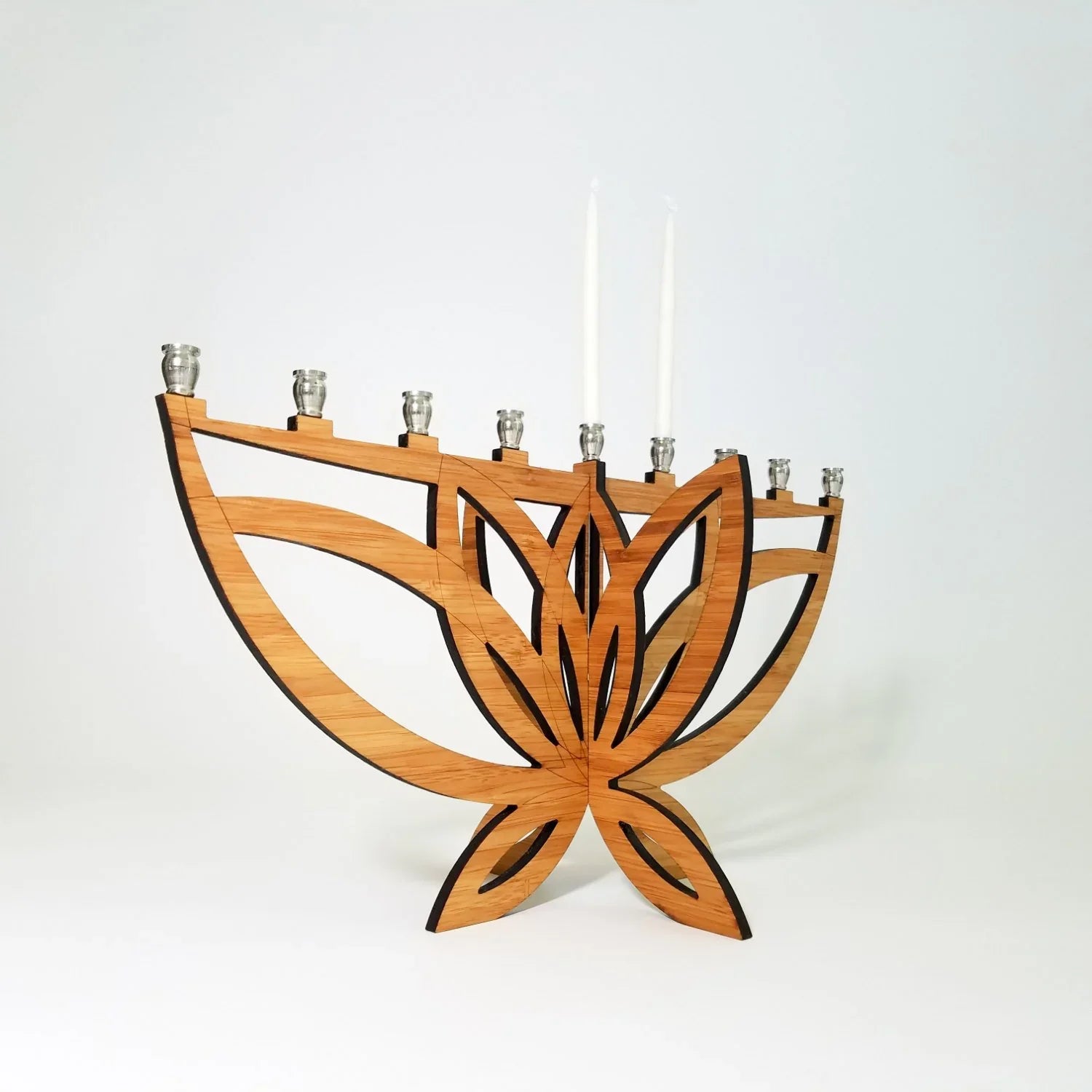 Modern wooden lotus flower menorah with eight candle holders and two lit white candles