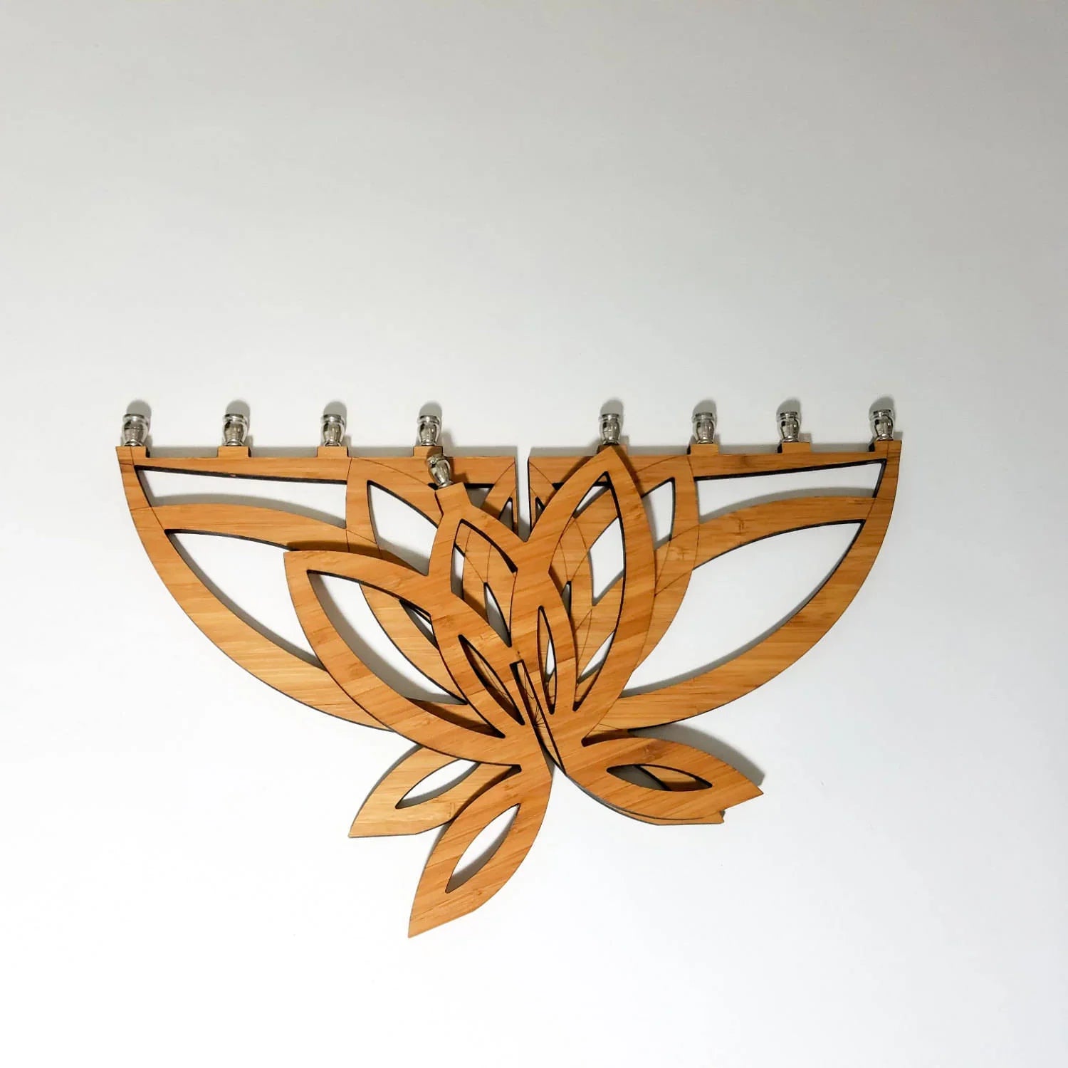 Wooden lotus flower Hanukkah menorah with seven candle holders, modern design on white background