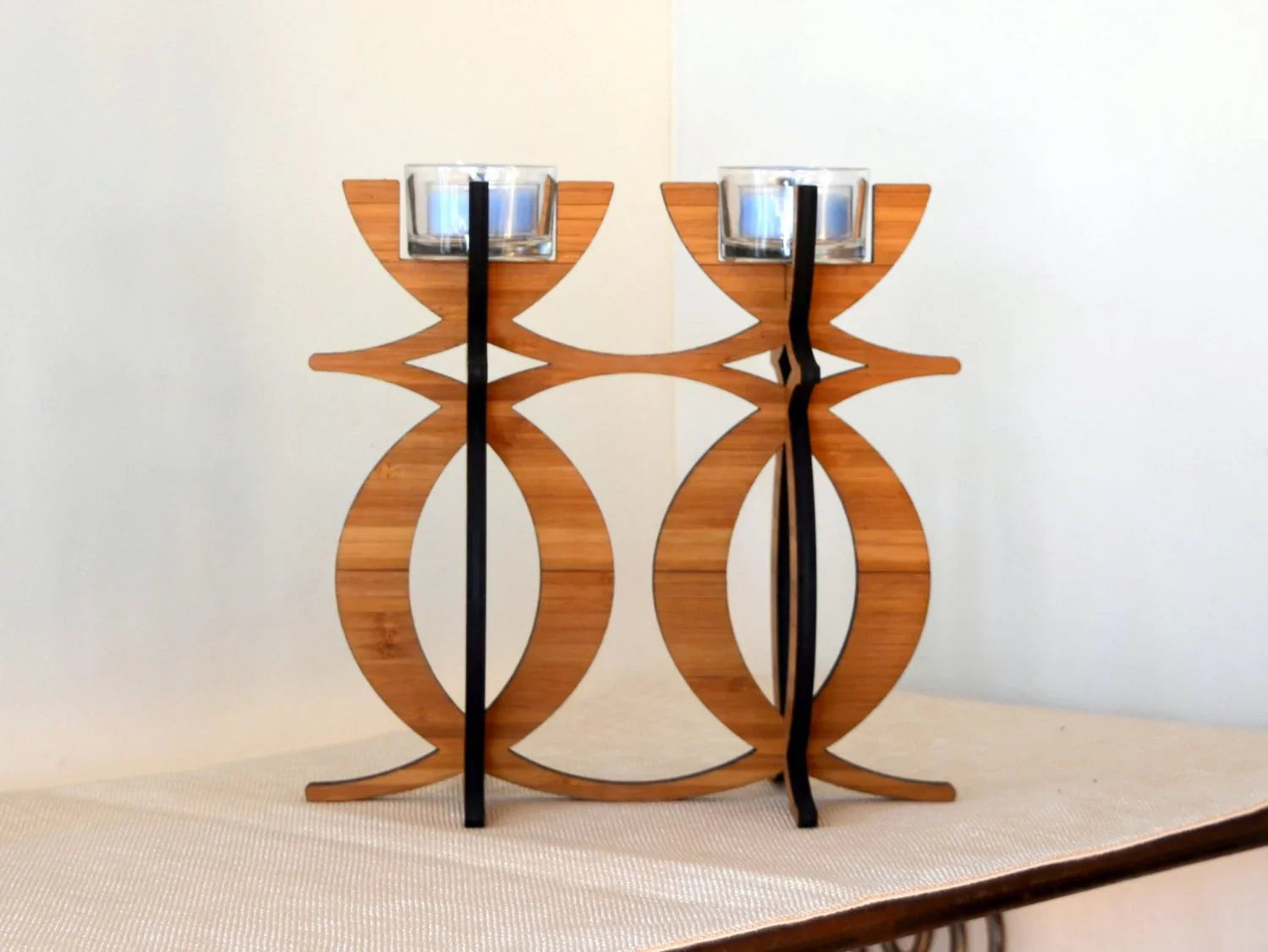 Eco-friendly bamboo tea light candelabra, modern design centerpiece on neutral table.