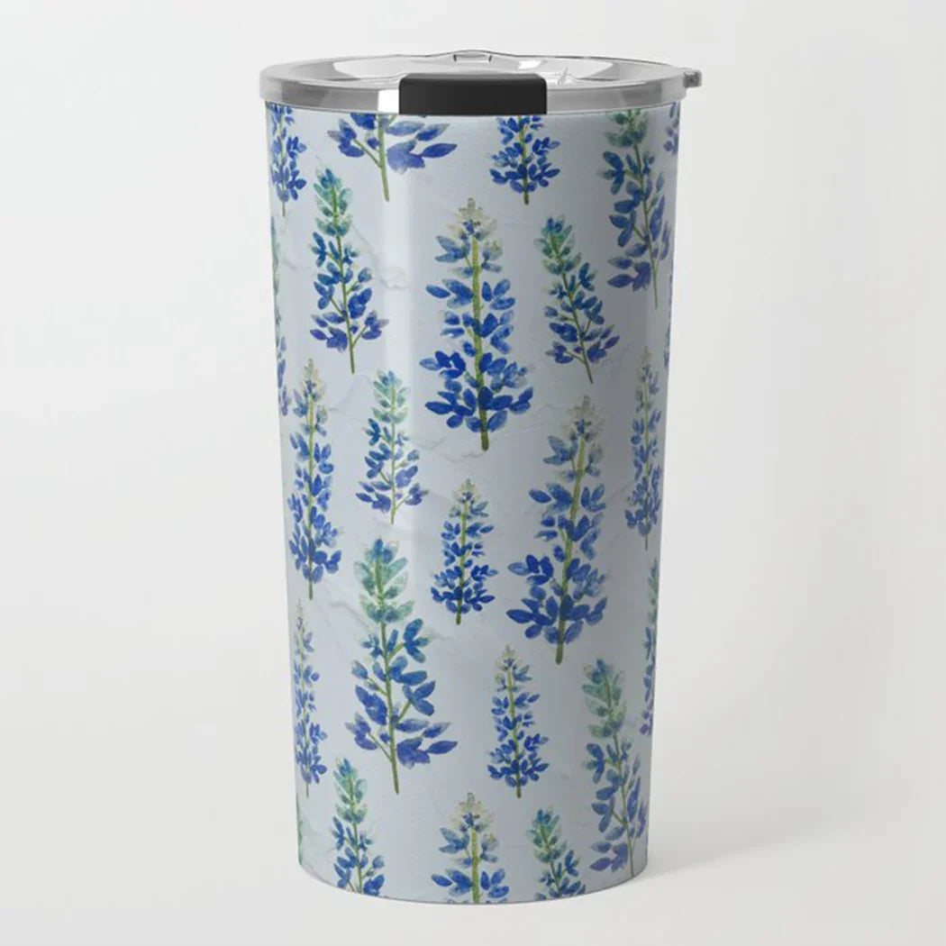 Stainless steel travel tumbler with blue and green floral pattern on white background