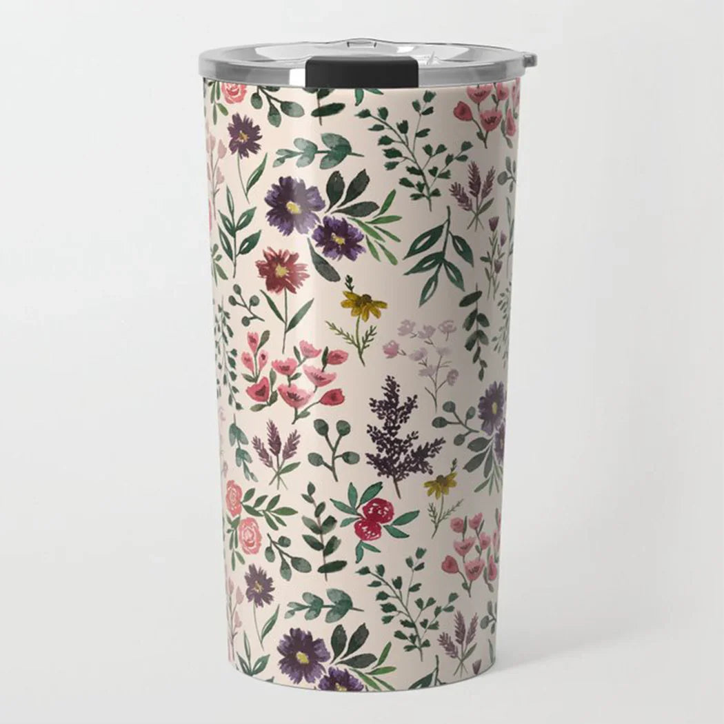Stainless steel tumbler with colorful floral pattern on a cream background and clear lid
