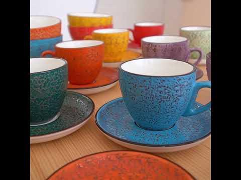 Colorful artist-designed ceramic teacups and saucers on display at Qu!rk Boutique gift shop.