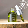 Herban Wisdom facial oil bottle with dropper on wood, EWG certified, at Qu!rk Boutique