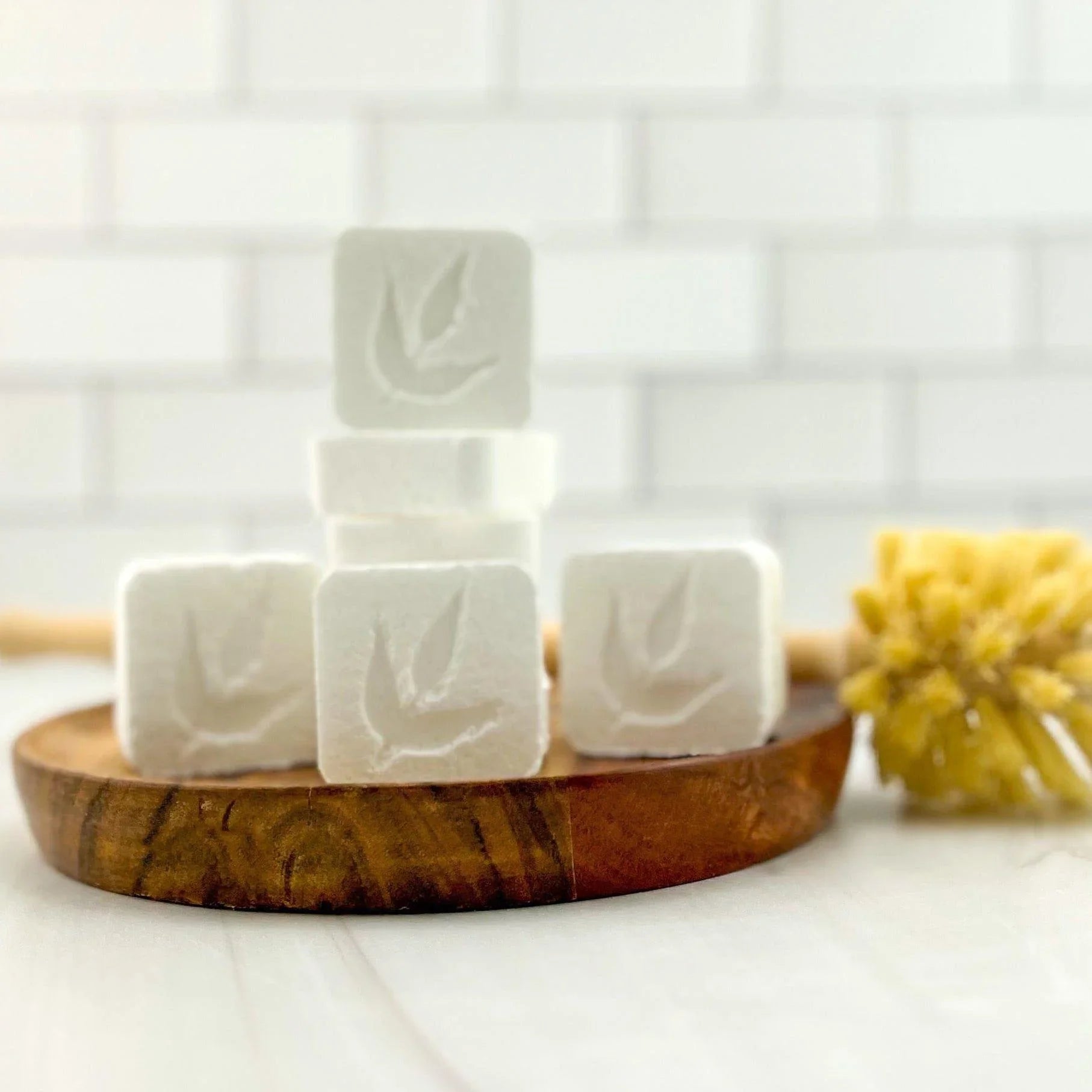 Eco-friendly white cleaning cubes with leaf imprint on wooden tray, Qu!rk Boutique.