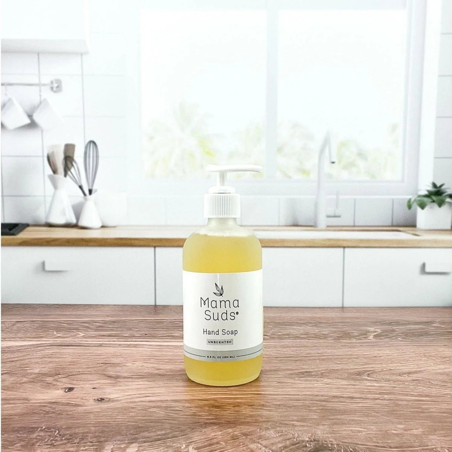 Mama Suds unscented hand soap bottle on wooden countertop in bright modern kitchen