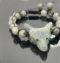 Labradorite wolf head beaded bracelet on black surface, artisan jewelry at Qu!rk Boutique