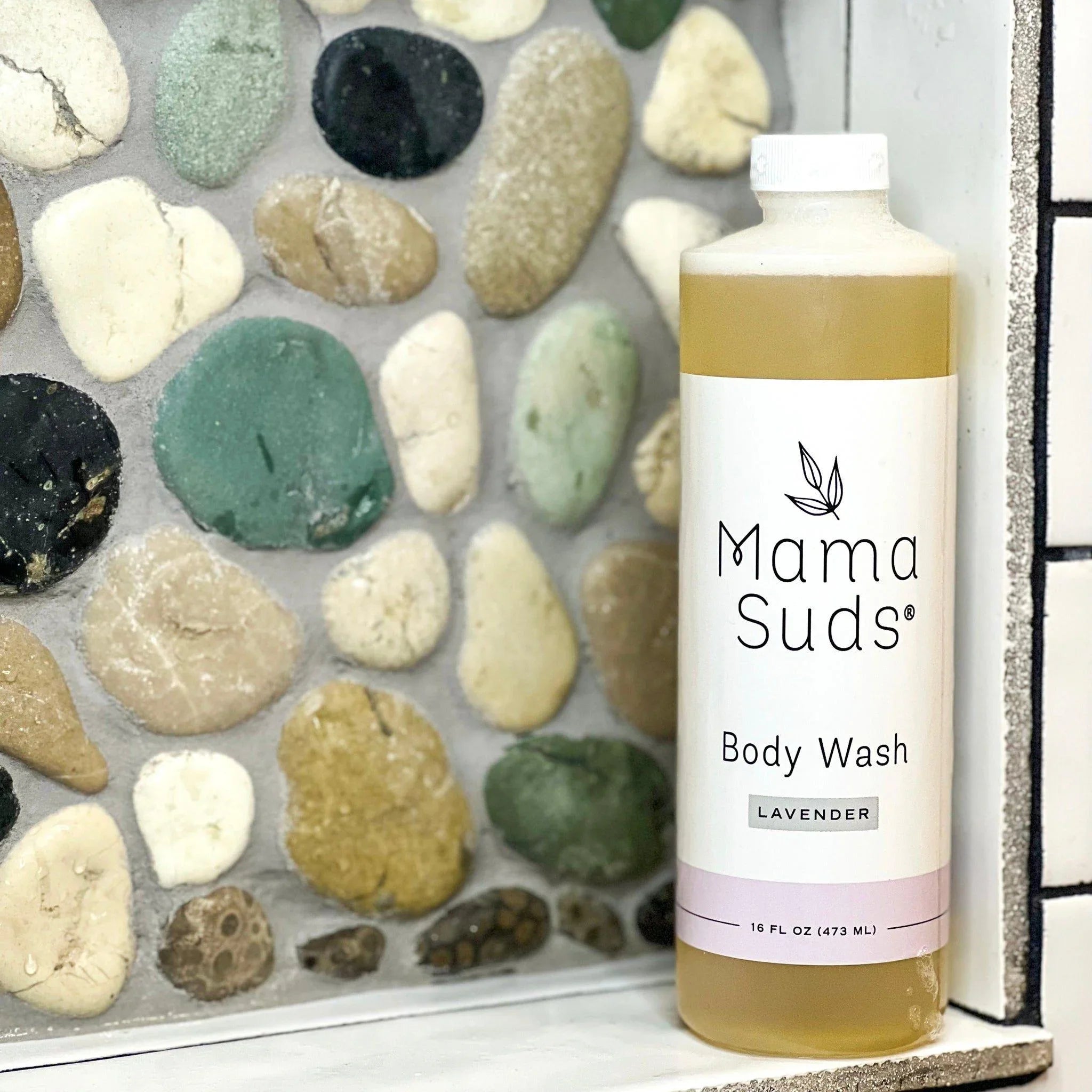 Mama Suds Lavender Body Wash 16oz bottle on stone tile shelf, boutique bath product