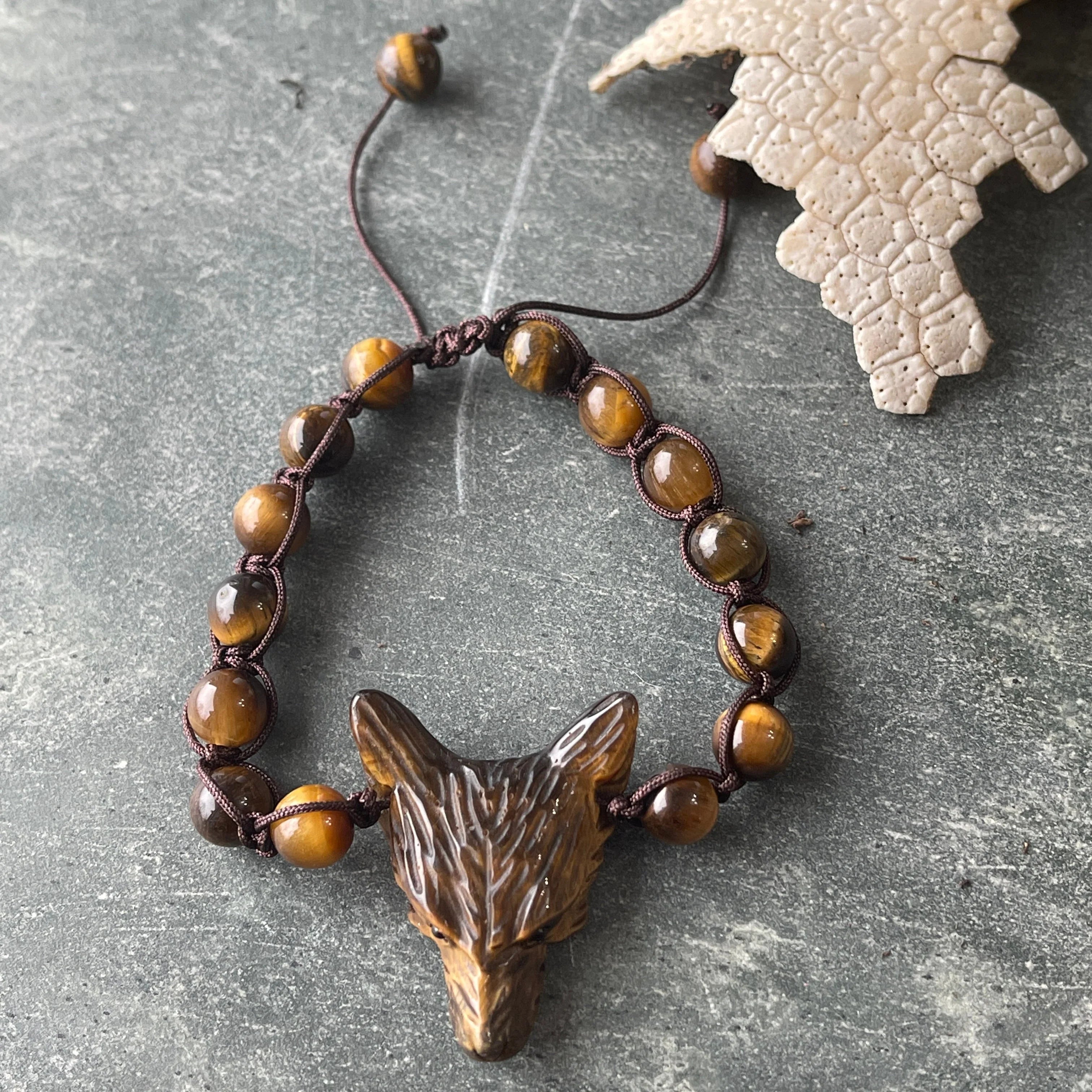 Handcrafted tiger's eye wolf bracelet on stone, artist-designed jewelry from Qu!rk Boutique