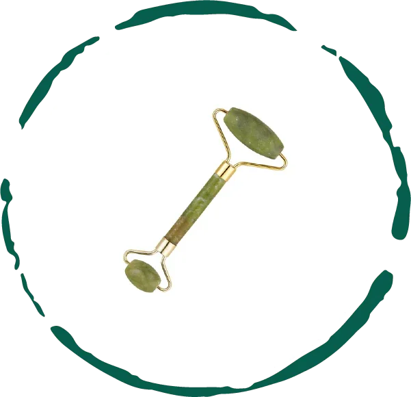 Green jade facial roller with gold accents on white background, Qu!rk Boutique beauty tool