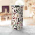Floral patterned stainless steel tumbler with silver lid on marble table in cozy living room