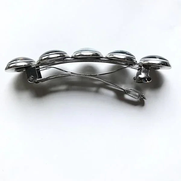 Silver metal hair clip with five rounded dome accents on a white background