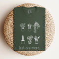 Green t-shirt with white potted plant drawings and 'just one more...' text, Qu!rk Boutique