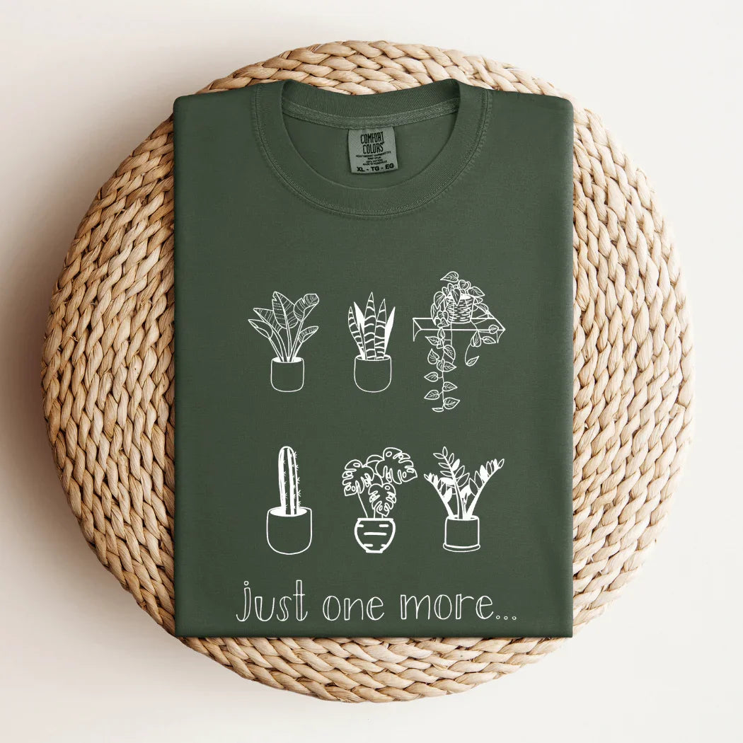 Green t-shirt with white potted plant drawings and 'just one more...' text, Qu!rk Boutique
