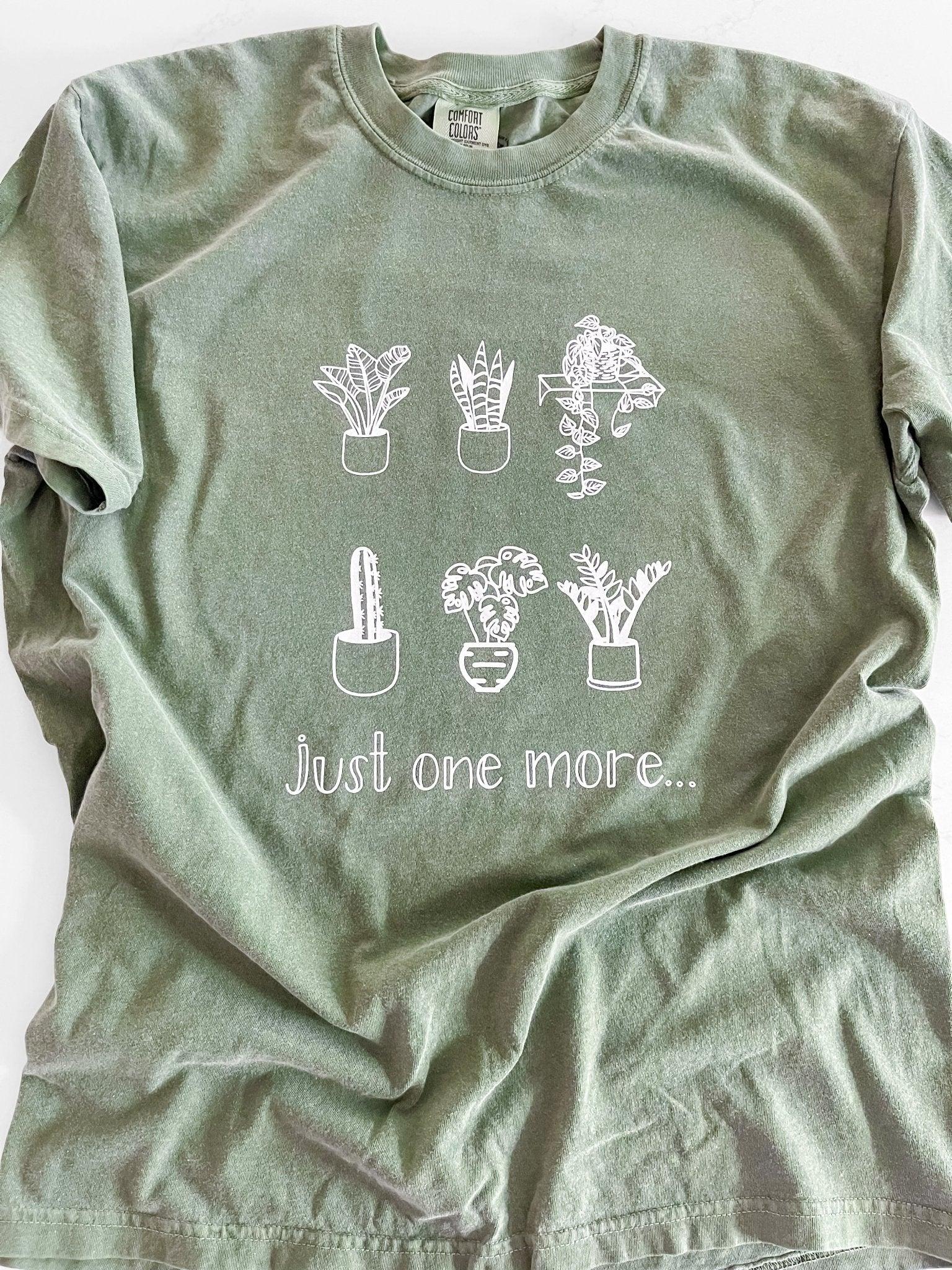 Sage green t-shirt with hand-drawn potted plants and 'just one more...' text, garden whimsy gift