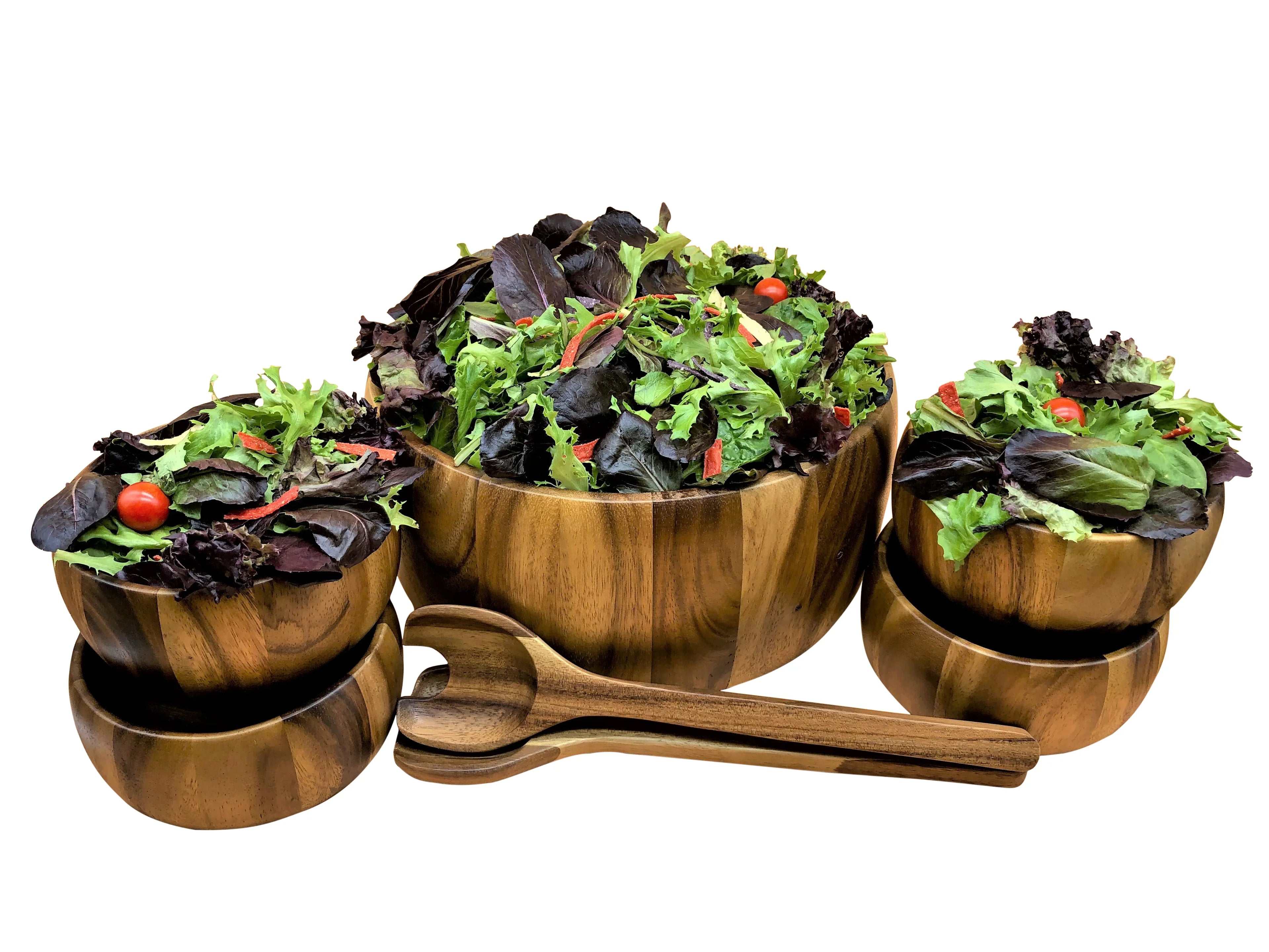 Wooden salad bowl set with fresh leafy salad and serving utensils, eco-friendly kitchenware