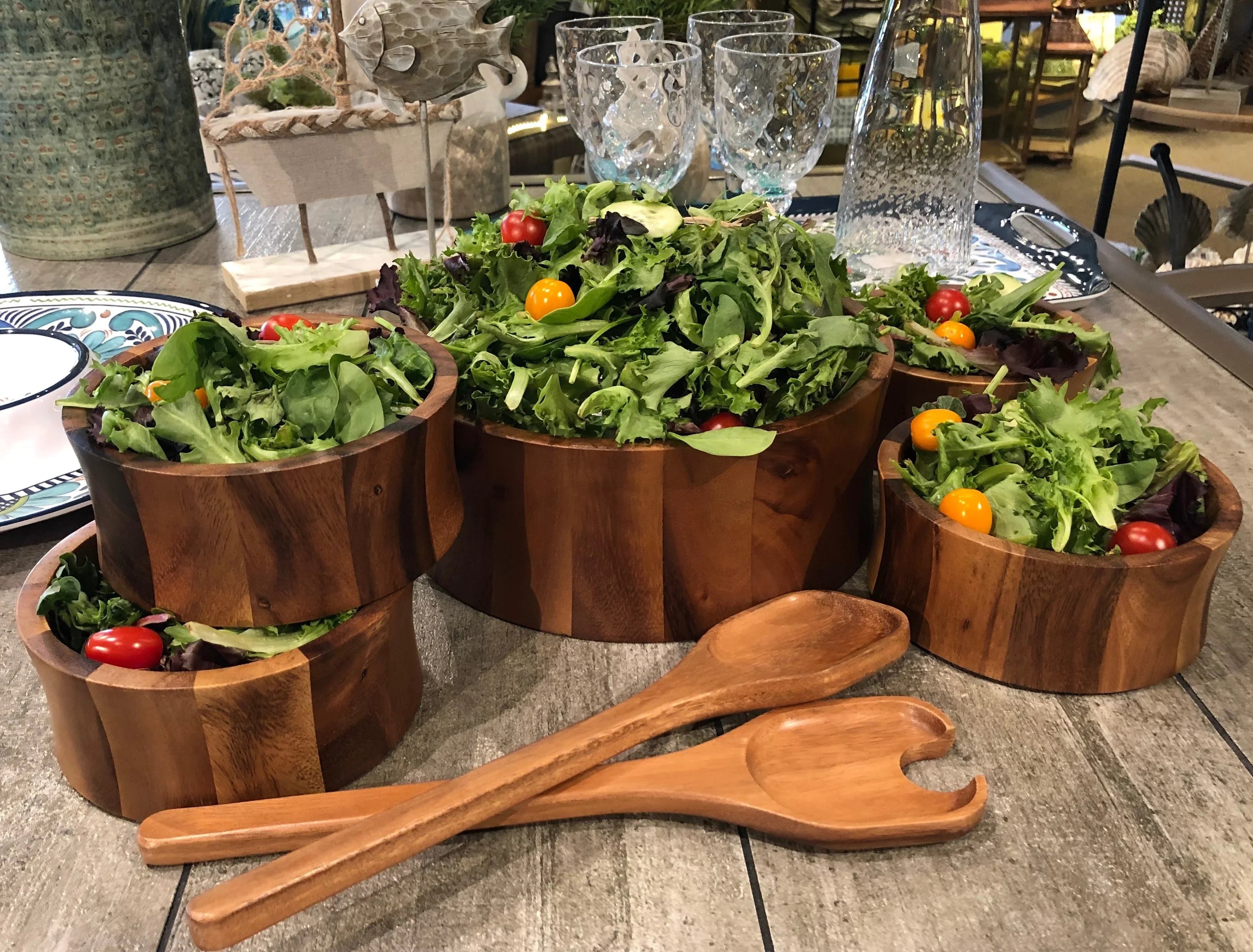 Wooden salad bowls with fresh greens and tomatoes, eco-friendly kitchenware at Qu!rk Boutique