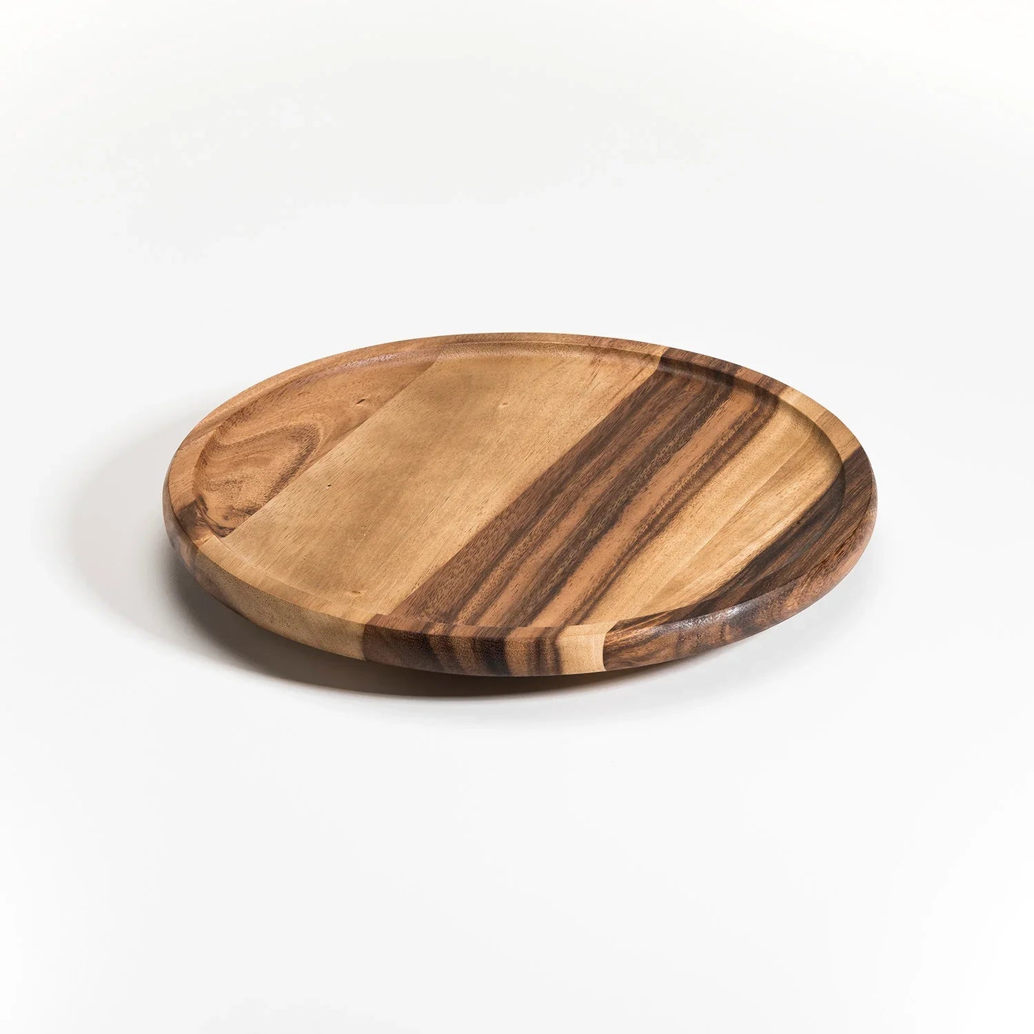 Handcrafted round wooden serving tray with natural wood grain on white background