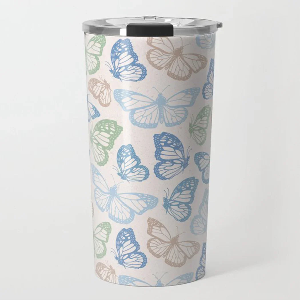 Tall insulated tumbler with blue, green, and beige butterfly pattern and clear lid