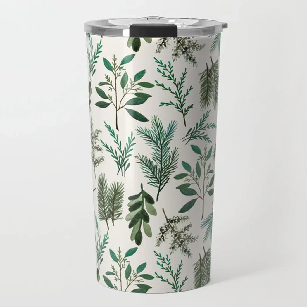Stainless steel tumbler with green leafy botanical pattern on white background